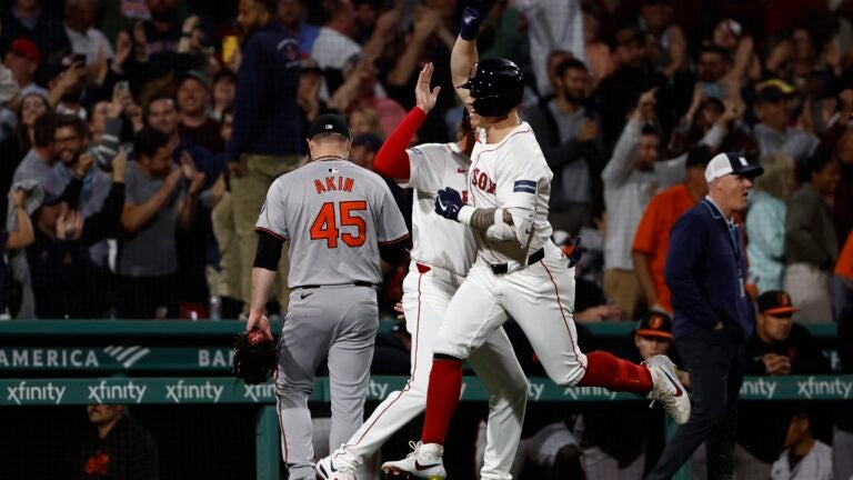 Tyler O'Neill of the Red Sox celebrates his game winning three-run home run during the 10th inning.