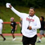 Jermaine Wiggins coaches his team during the 1st day of football practice at the Marciano Stadium.