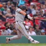 Dominic Fletcher of the White Sox hits a double in front of Red Sox catcher Connor Wong in the ninth inning.