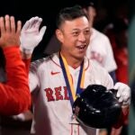 Boston Red Sox's Rob Refsnyder, right, is congratulated after his home run, his second of the night, during the eighth inning of a baseball game against the Baltimore Orioles at Fenway Park, Monday, Sept. 9, 2024, in Boston.