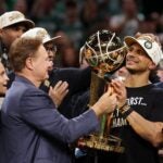 BOSTON, MASSACHUSETTS - JUNE 17: Head coach Joe Mazzulla of the Boston Celtics lifts the Larry O’Brien Championship Trophy after Boston's 106-88 win against the Dallas Mavericks in Game Five of the 2024 NBA Finals at TD Garden on June 17, 2024 in Boston, Massachusetts.