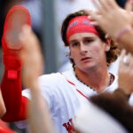 Worcester Red Sox outfielder Roman Anthony (19) is high-fived by teammates after scoring a run in his first game at Polar Park.