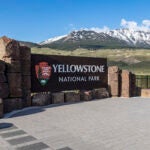 FILE - This photo provided by the National Park Service shows a sign marking the north entrance of Yellowstone National Park, May 7, 2018.