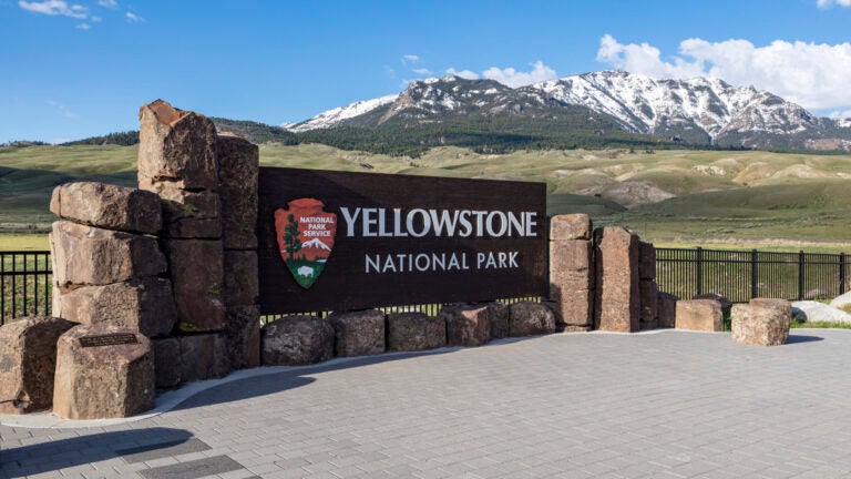 General News FILE - This photo provided by the National Park Service shows a sign marking the north entrance of Yellowstone National Park, May 7, 2018.