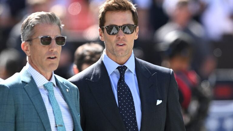 Broadcasters Kevin Burkhardt and Tom Brady walk along the field before the game between the Dallas Cowboys and Cleveland Browns at Cleveland Browns Stadium on September 08, 2024 in Cleveland, Ohio.