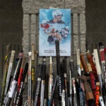 Flowers and hockey sticks mark a roadside memorial to brothers John and Matthew Gaudreau in Oldmans Township, N.J. on Sept. 5, 2024. The night before their sister’s wedding, John and Matthew were fatally struck by a car while riding bicycles near their family home in rural New Jersey.