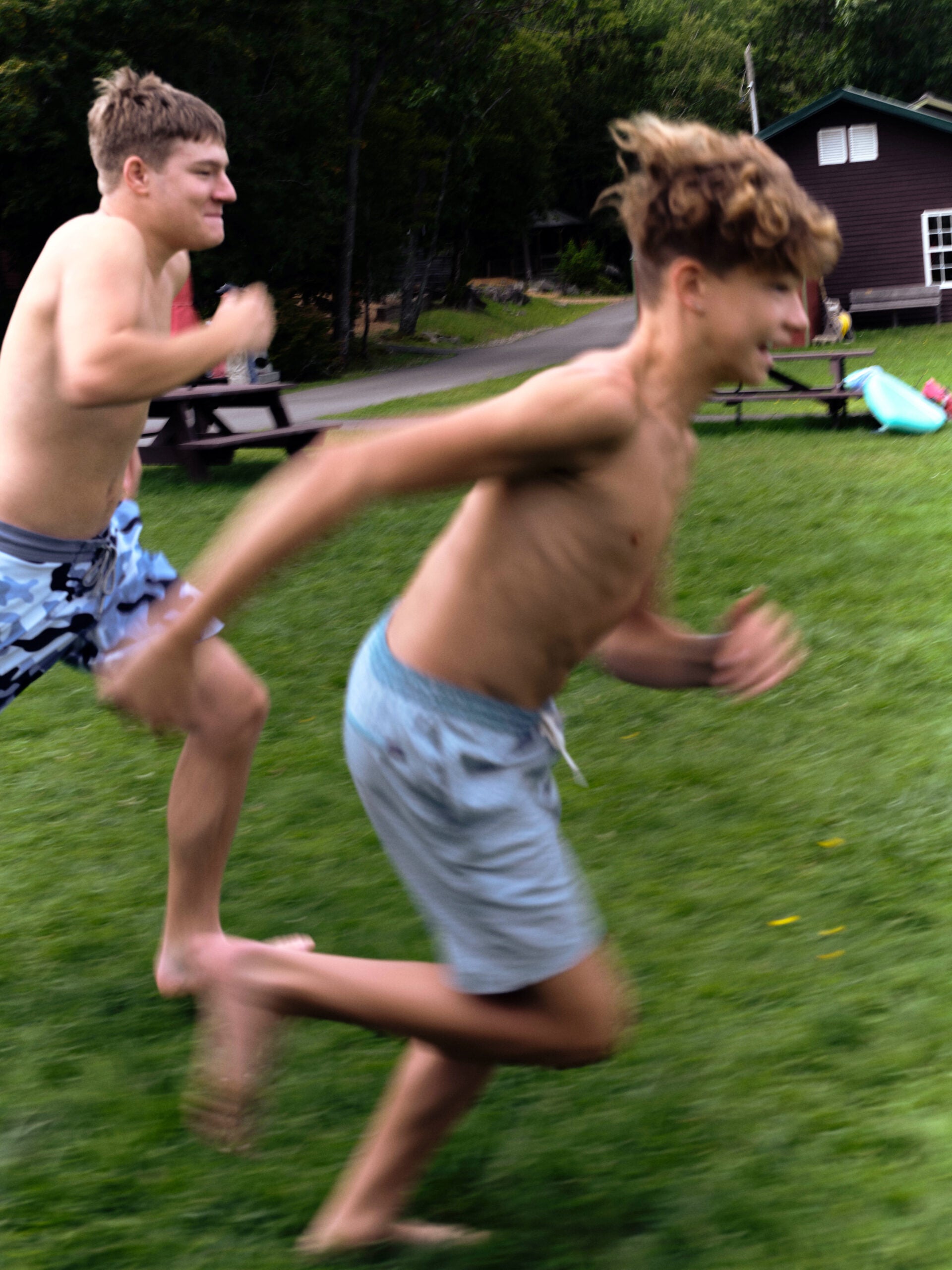 Two campers race to the pond during Pine Creek Camp's Dirigo Experience.