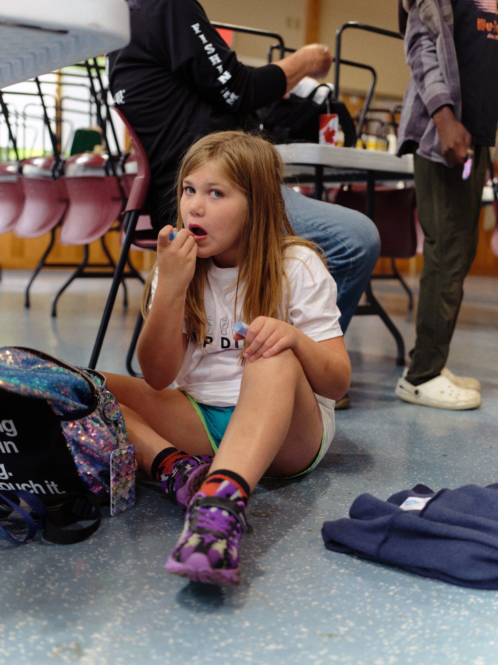 A camper applies lip balm during Pine Creek Camp's Dirigo Experience.
