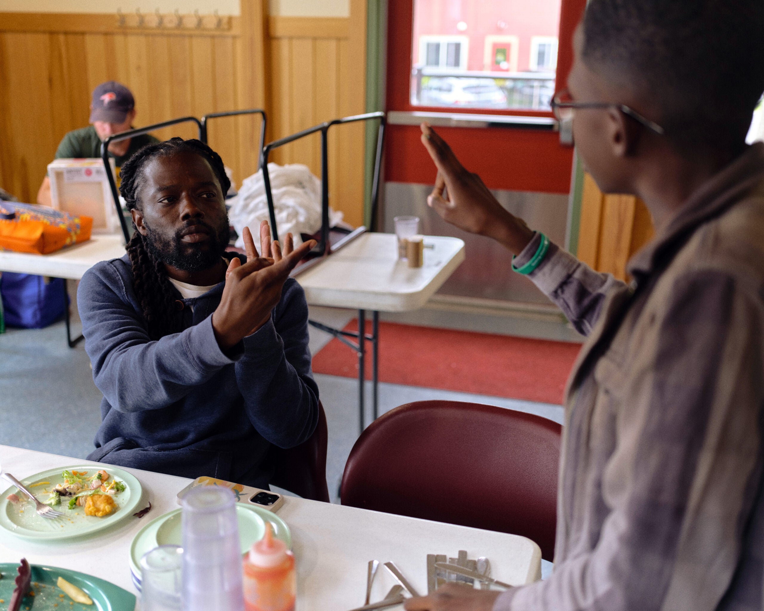 A counselor converses with a camper in American Sign Language during Pine Creek Camp's Dirigo Experience. 