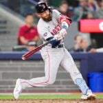 Trevor Story of the Red Sox hits an RBI double against the Blue Jays in the 10th inning.