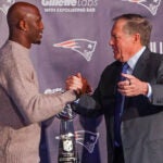 Devin McCourty and New England Patriots head coach Bill Belichick share an embrace during his retirement presser at Patriots Hall of Fame.