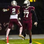 Two Dedham High School football players at a game in 2023.