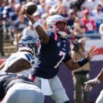 Patriots quarterback Jacoby Brissett throws a pass under pressure Sunday.