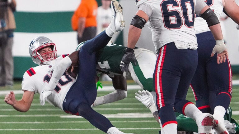 New England Patriots quarterback Drake Maye (10) hits the turf hard after trying to gain a few yards during the fourth quarter. The New York Jets host the New England Patriots in a Thursday night football game at Met Life stadium in East Rutherford, NJ.