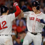 Red Sox Tyler O’Neill celebrates his solo home run against the Orioles with teammate Connor Wong at Fenway Park.