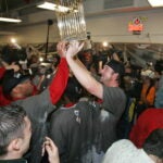 Derek Lowe hoists the Commissioner's Trophy after the Red Sox won the 2004 World Series.