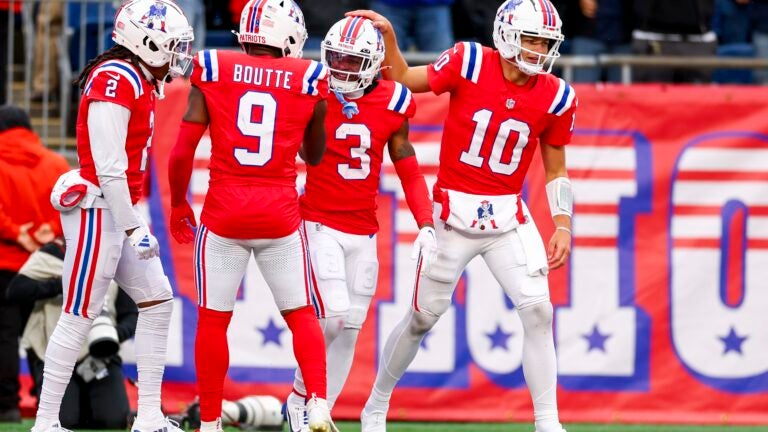 Drake Maye #10 of the New England Patriots celebrates with teammate DeMario Douglas #3 after a touchdown during the fourth quarter against the Houston Texans at Gillette Stadium on October 13, 2024 in Foxborough, Massachusetts.
