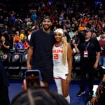 Jayson Tatum poses for a photo with DiJonai Carrington.