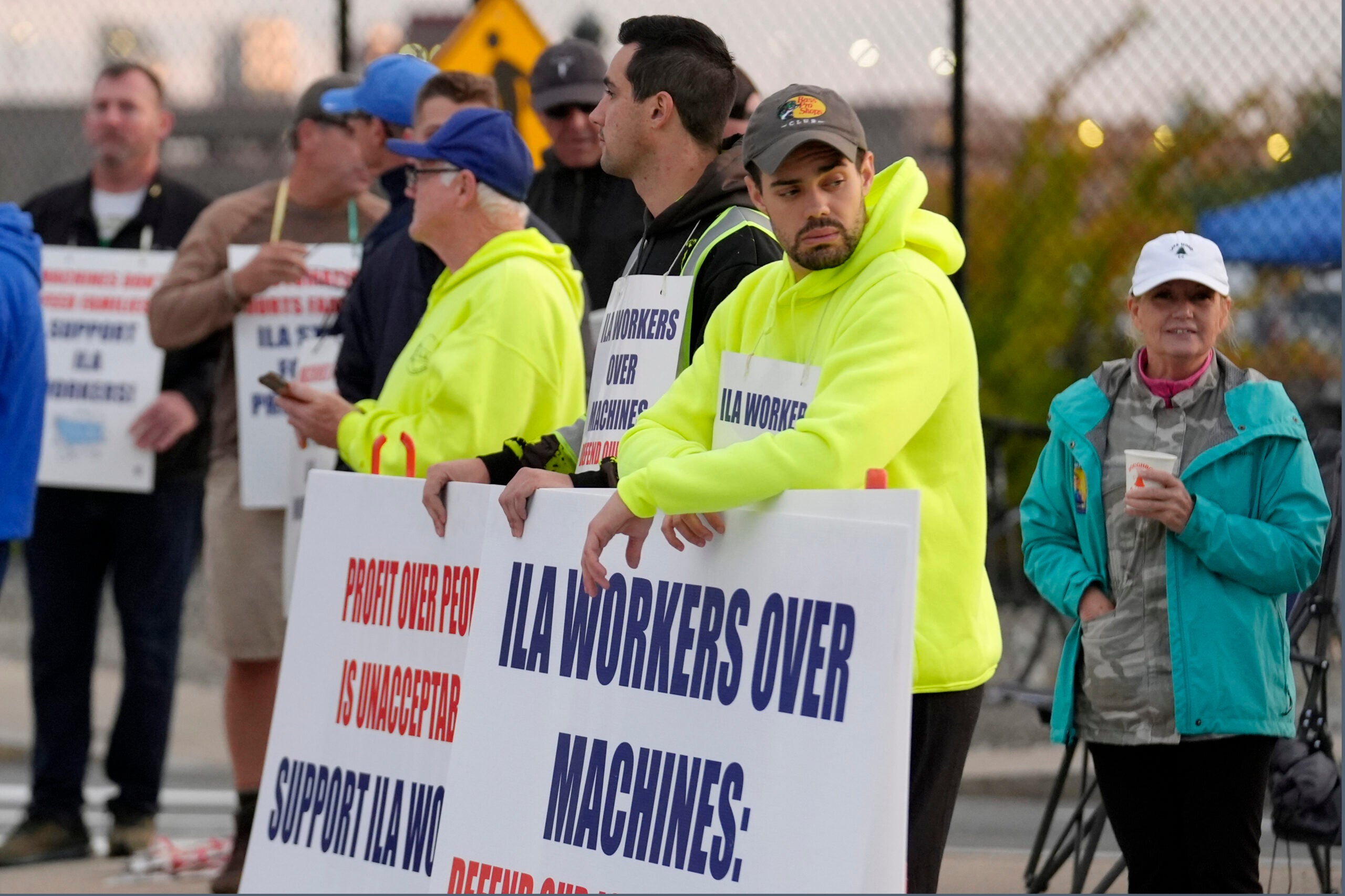 Dockworkers strike outside the entrance to a container terminal near Boston Harbor.