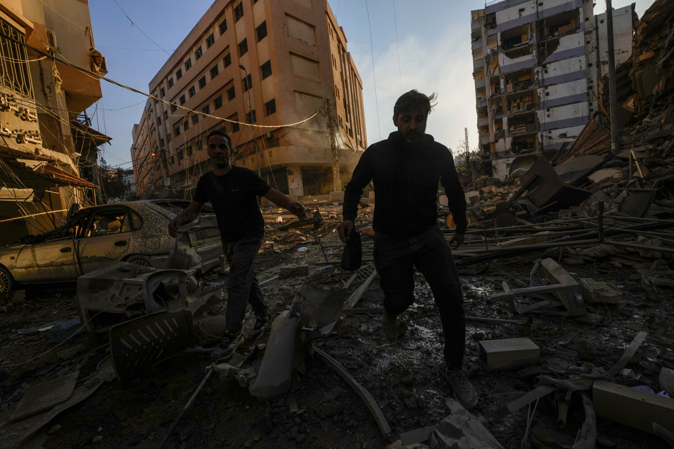 Residents run for cover following an Israeli airstrike in Dahiyeh, Beirut, Lebanon.