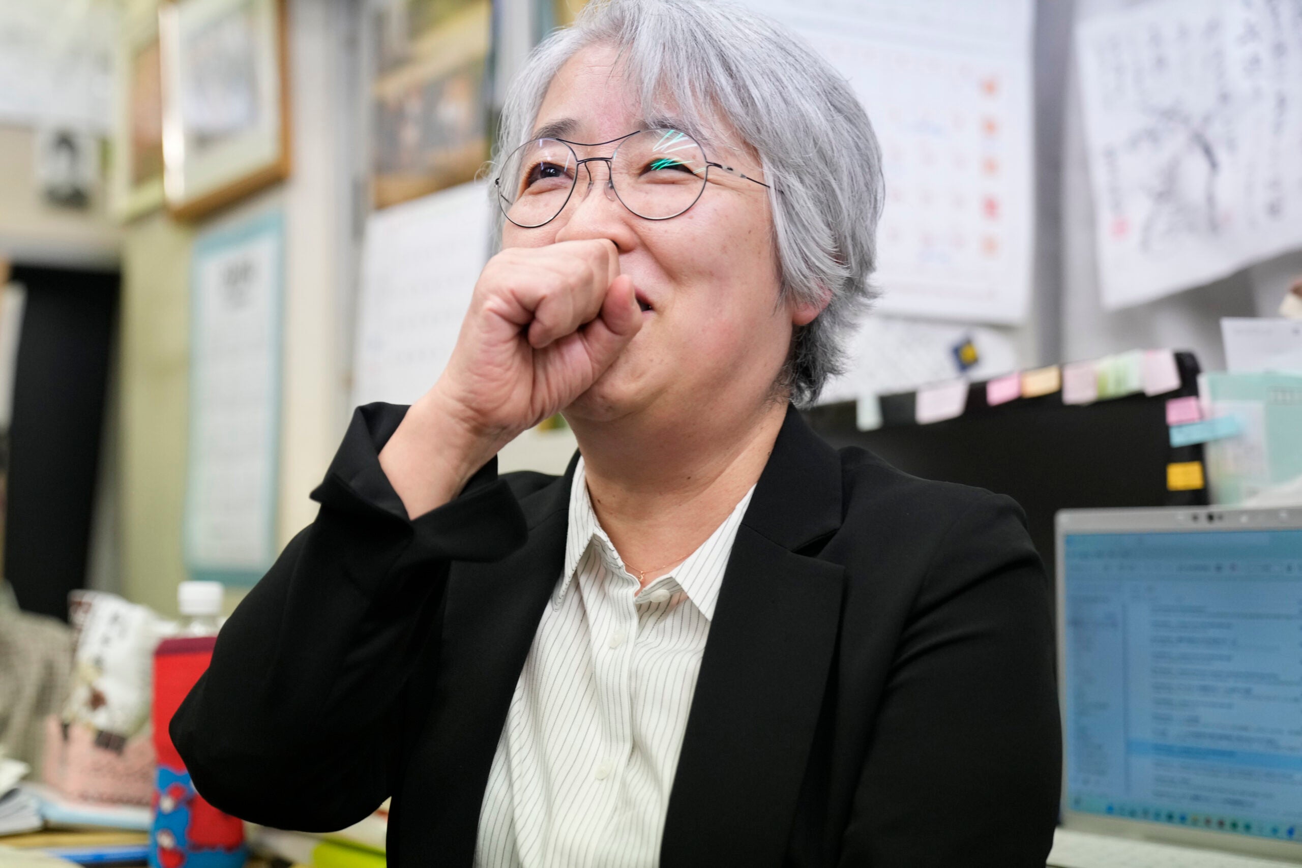 Masako Kudo reacts while speaking to media members.