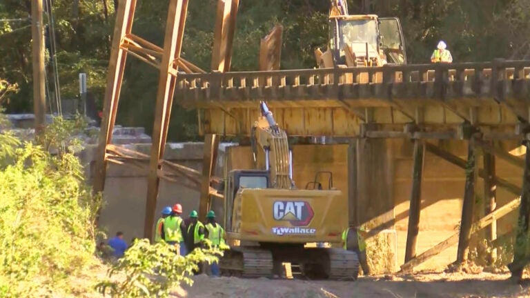 This image taken from video from WLBT shows construction workers at the scene after a bridge over the Strong River on State Route 149 in Simpson County, Miss., collapsed on Wednesday, Oct. 16, 2024.