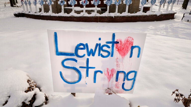 Snow coats crosses at one of several memorials for the victims of the mass shooting in Lewiston, Maine.