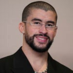 Bad Bunny poses in the press room at the Oscars.