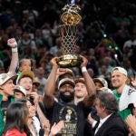 Jaylen Brown holds up the Larry O'Brien Championship Trophy after the Celtics' victory.