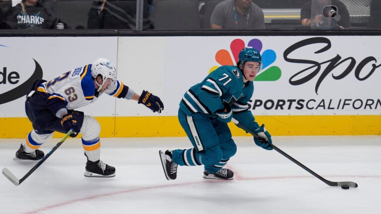 Blues' Jake Neighbours chases after Macklin Celebrini.