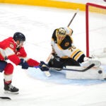 Boston Bruins goaltender Joonas Korpisalo (70) makes a save against Florida Panthers center Aleksander Barkov (16) during the second period of an NHL hockey game, Tuesday, Oct. 8, 2024, in Sunrise, Fla.