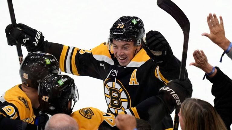 Boston Bruins' Charlie McAvoy (73) celebrates the goal by Mark Kastelic (47) during the first period of an NHL hockey game against the Montreal Canadiens, Thursday, Oct. 10, 2024, in Boston.