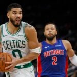 Jayson Tatum goes to the basket past Pistons guard Cade Cunningham.
