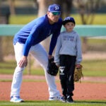 Dodgers' Freddie Freeman and his son Charlie participate in spring training workouts.