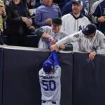 NEW YORK, NEW YORK - OCTOBER 29: Fans interfere with Mookie Betts #50 of the Los Angeles Dodgers as he attempts to catch a fly ball in foul territory during the first inning of Game Four of the 2024 World Series against the New York Yankees at Yankee Stadium on October 29, 2024 in the Bronx borough of New York City. The play resulted in an out.