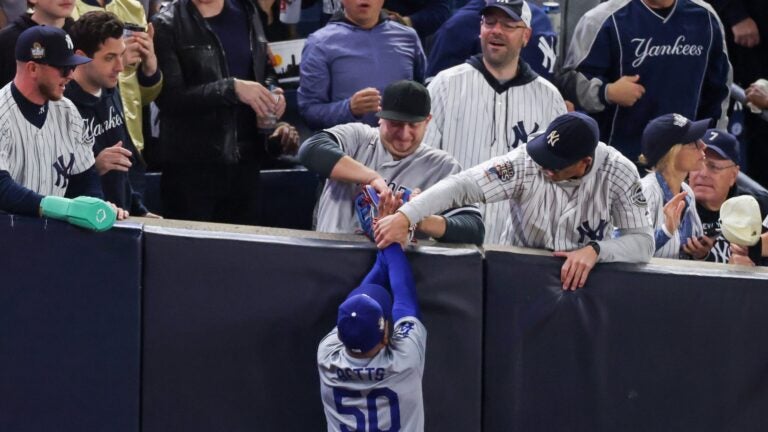 Yankees fans rip the ball out of Betts' glove during the World Series