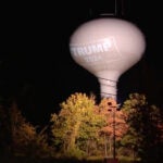 A Trump 2024 logo is projected onto a water tower in Hanson, Massachusetts.