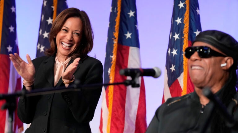 Democratic presidential nominee Vice President Kamala Harris listens as Stevie Wonder performs "Redemption Song" during a church service and early vote event at Divine Faith Ministries International, Sunday, Oct. 20, 2024, in Jonesboro, Ga.