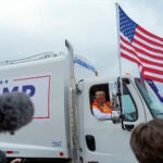 Republican presidential nominee former President Donald Trump talks to reporters as he sits in a garbage truck Wednesday, Oct. 30, 2024, in Green Bay, Wis.