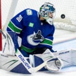 Calgary Flames' Jake Bean, not seen, scores on Vancouver Canucks goaltender Jiri Patera (30) during the second period of a preseason NHL hockey game in Abbotsford, British Columbia, Wednesday, Sept. 25, 2024.