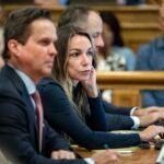 Karen Read sitting in court with her legal team.