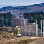 FILE - Heavy machinery is used to cut trees to widen an existing Central Maine Power power line corridor to make way for new utility poles, April 26, 2021, near Bingham, Maine.
