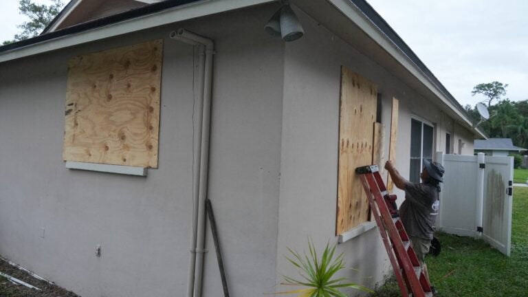 A resident boards up his windows in Palm Harbor, Florida on Sunday, ahead of Hurricane Milton's expected mid-week landfall.