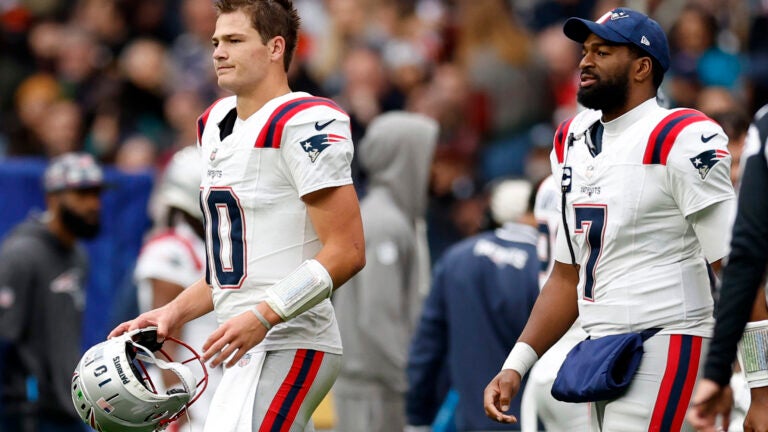 New England Patriots quarterbacks Drake Maye (10) and Jacoby Brissett (7) on the field during the second quarter at Wembley Stadium.