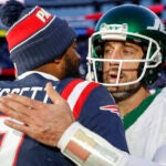 New England Patriots quarterback Jacoby Brissett (7) hugs New York Jets quarterback Aaron Rodgers (8) after defeating the Jets 25-22 in an NFL football game on Sunday, Oct. 27, 2024, in Foxborough, Mass.