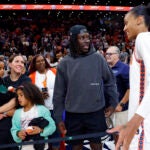 Jrue Holiday talks to DeWanna Bonner after the Sun's game at TD Garden.