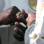 Boston Celtics guard Jaylen Brown admires his ring as the 2024 World Championship banner is raised prior to an NBA basketball game against the New York Knicks, Tuesday, Oct. 22, 2024, in Boston.