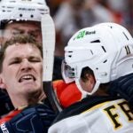 SUNRISE, FLORIDA - OCTOBER 08: Matthew Tkachuk #19 of the Florida Panthers scraps with Trent Frederic #11 of the Boston Bruins during the third period at Amerant Bank Arena on October 08, 2024 in Sunrise, Florida.