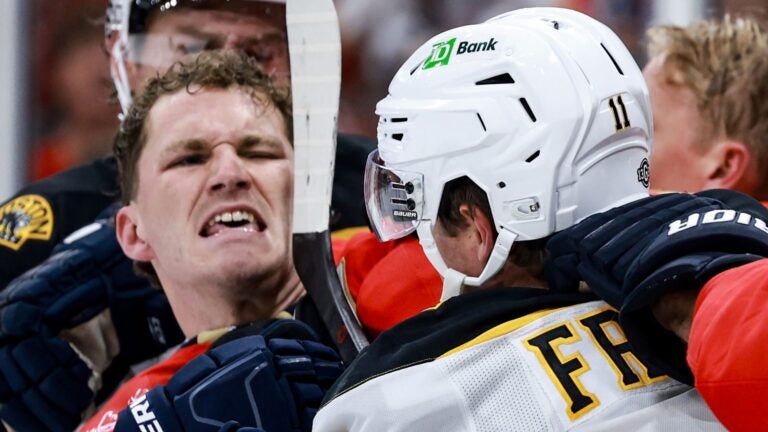 SUNRISE, FLORIDA - OCTOBER 08: Matthew Tkachuk #19 of the Florida Panthers scraps with Trent Frederic #11 of the Boston Bruins during the third period at Amerant Bank Arena on October 08, 2024 in Sunrise, Florida.