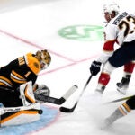 Bruins goaltender Jeremy Swayman makes a save on a shot by Florida Panthers center Carter Verhaeghe during the first period.
